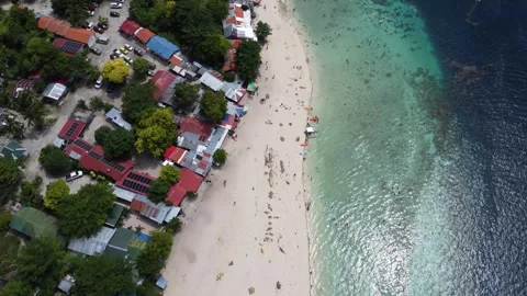 Drone flight over Moalboal White Beach coastline with tropical sea jungle an Stock Footage 335395736