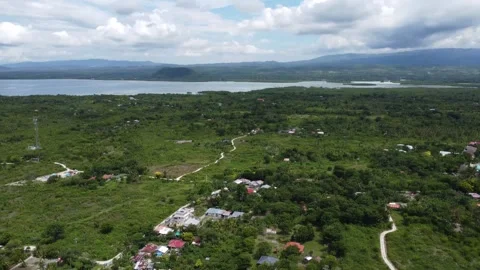 Drone flight over Moalboal White Beach coastline with tropical sea jungle an Stock Footage 335396063