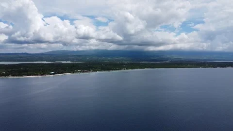 Drone flight over Moalboal White Beach coastline with tropical sea jungle an Stock Footage 335396655