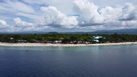 Drone flight over Moalboal White Beach coastline with tropical sea jungle an Stock Footage 335397189