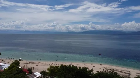 Drone flight over Moalboal White Beach coastline with tropical sea jungle an Stock Footage 335397240
