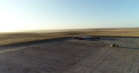 Drone flight over a mostly empty fracking pad before the big operation Stock Footage 167931348
