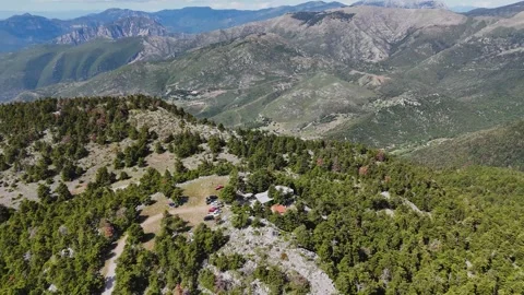 Drone flight over mountain forest and chapel on rocky ridge, Greece Stock-Footage 332822538