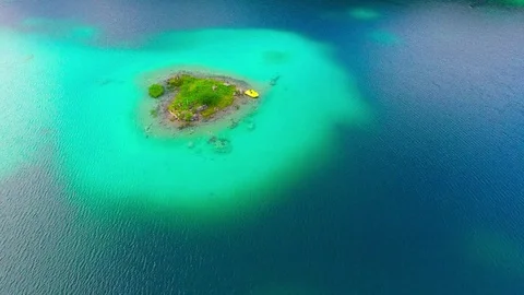 Drone flight over mountain lake Eibsee beneath Zugspitze peak. Video stock 84835165