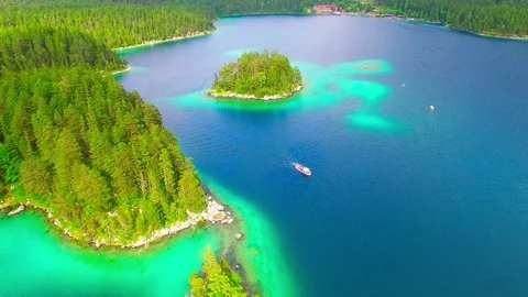 Drone flight over mountain lake Eibsee beneath Zugspitze peak. Video stock 84838067
