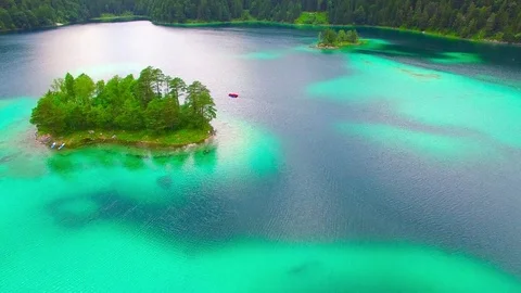 Drone flight over mountain lake Eibsee beneath Zugspitze peak. Video stock 84840000