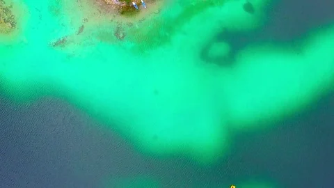 Drone flight over mountain lake Eibsee beneath Zugspitze peak. Video stock 84840262