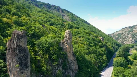 Drone flight over mountains and country road in summer day.  Stock Footage 114480395