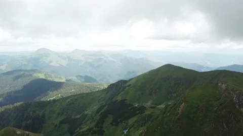 Drone flight over mountains and flag at the top Stock Footage 137921480