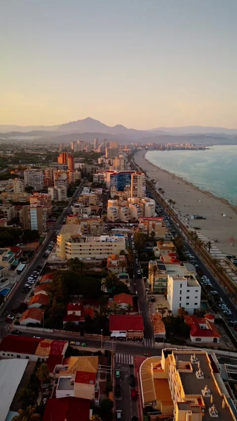 Drone flight over Muchavista beach and urban skyline at sunset Stock Footage 311065755