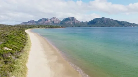 Drone flight over Muirs beach, Coles Bay &amp; Hazards mountains, Tasmania Stock Footage 169266288