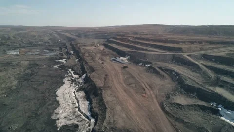 Drone flight over multi-tiered road - serpentine in to deep quarry for Stock Footage 203918049