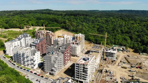 Drone flight over a new building under construction near a forest Stock Footage 139962859