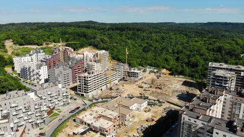 Drone flight over a new building under construction near a forest Stock Footage 139969818