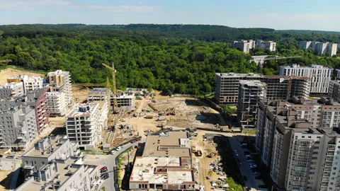 Drone flight over a new building under construction near a forest Stock Footage 140258176