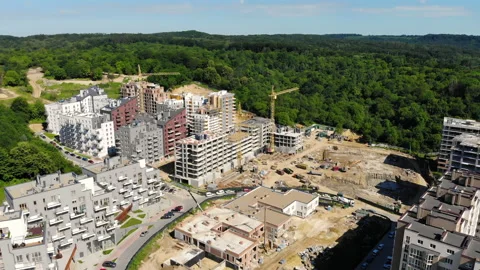 Drone flight over a new building under construction near a forest Stock Footage 140592311