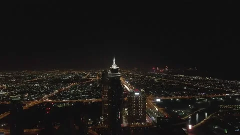 Drone flight over the night illuminated streets of Dubai Vídeo Stock 221304029