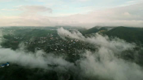 Drone flight over Nuwara Eliya at sunrise, misty mountains, awakening town Stock Footage 274939155
