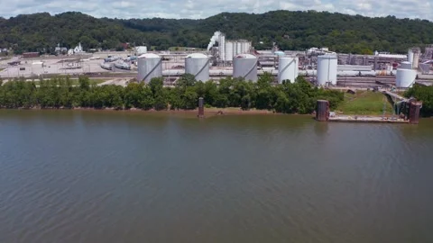 Drone flight over Ohio river approaching chemical plant 4k Stock Footage 147987668