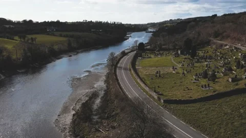 Drone flight over the old catalic cemetery near the river with a bridge Video stock 234111415