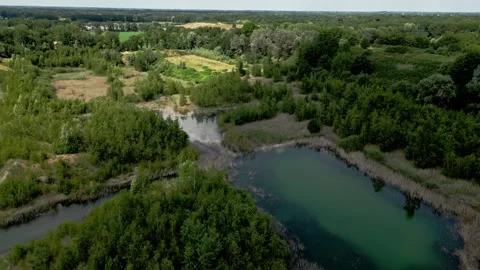 A drone flight over an old sand quarry that ends over a  wastdump Video stock 277486408