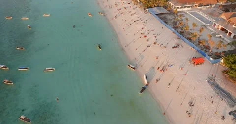 Drone Flight Over People Playing on Nungwi Beach at Sunset, Zanzibar Stock Footage 327414183