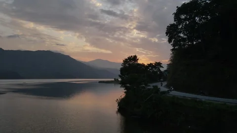 Drone flight over Phewa Lake with a man fishing on a boat with Nepal Valley. Stock Footage 244716372