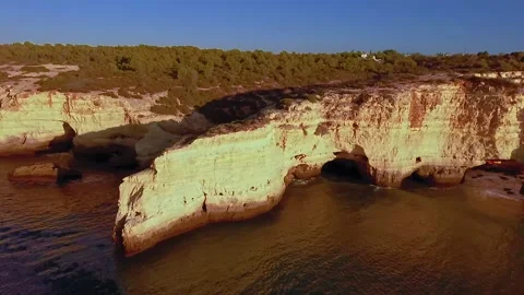 Drone flight over Praia de Marinha in Portugal during sunrise Stock Footage 132096710