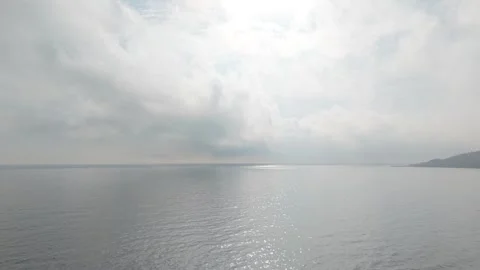 Drone Flight Over Quiet Water and Clouds Stock Footage 321121677