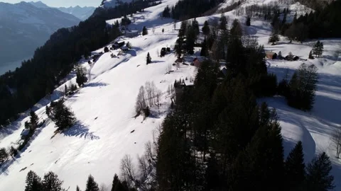 Drone flight over remote houses on a snowy mountain resort in Switzerland Video stock 170485331