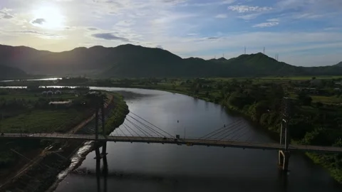 Drone flight over river bridge and mountains at sunset in Da Nang Vietnam Video stock 337948497