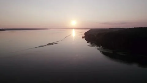 Drone flight over a river directly to the sunrise Stock Footage 204737819