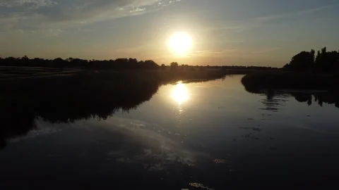 Drone flight over the river in the setting sun Stock Footage 246705739