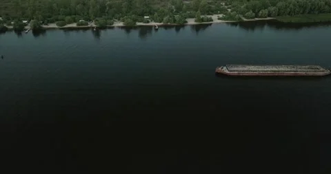 Drone flight over the river by ships walking along it on a cloudy day. Ukraine Stock Footage 136818534