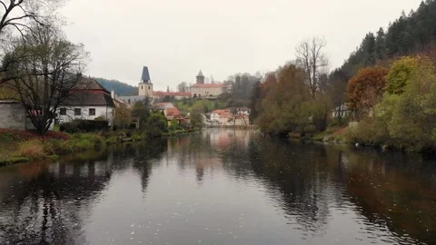 Drone flight over the river in a small historical czech town in autumn time Stock Footage 257875620