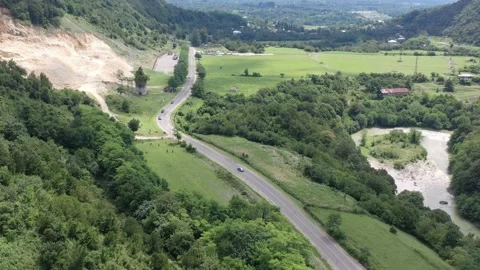 Drone flight over the road along the mountain river Stock Footage 151189616