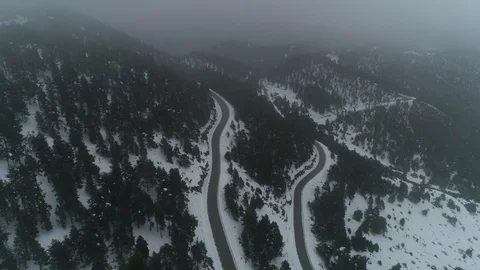 Drone flight over road and snowy forest Stock Footage 125699594
