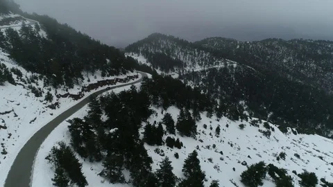 Drone flight over road and snowy forest Stock Footage 125700513