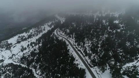 Drone flight over road and snowy forest Stock Footage 125700680