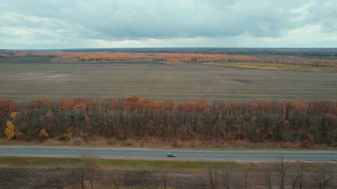 Drone flight over the road and field in late Stock Footage 164111590