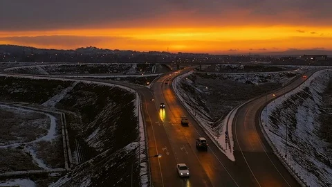 Drone flight over a road junction at sunset Stock Footage 104522380
