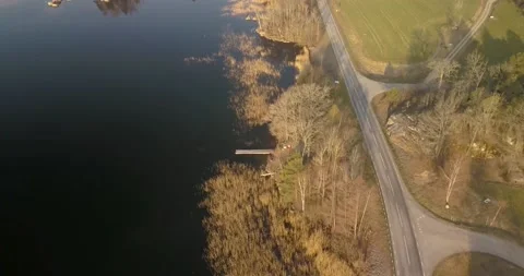 Drone flight over road by lake Stock Footage 221188878
