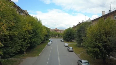 Drone flight over the roadway between trees Stock Footage 94321258