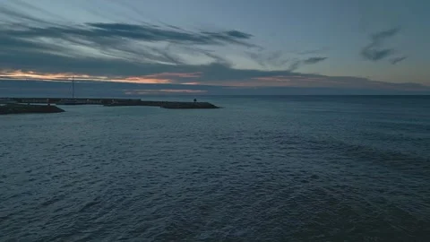 Drone flight over Roc de Sant Gaieta coast reveals Roda de Bara marina at dawn Stock Footage 263061513