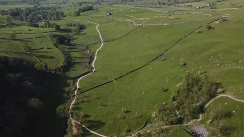 Drone Flight Over Rocky Cliff in a Lush Green Valley Stock Footage 242798511
