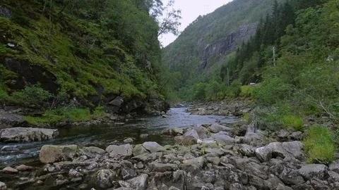 Drone flight over a rocky mountain river in Norway mountain valley low-angle Stock-Footage 301383741