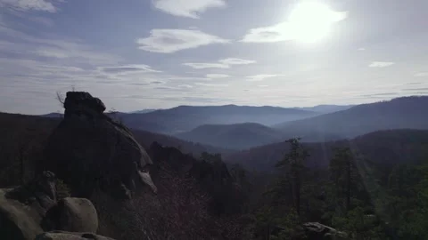 Drone Flight Over Rocky Mountain Landscape With Forest and Sun Rays Stock Footage 327206480