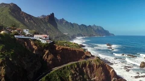 Drone flight over Roque de las Bodegas coastal road and Atlantic waves, Tenerife Stock Footage 336447591