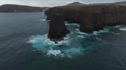 Drone flight over Roque del Farallon sea stack, Galdar coast, Gran Canaria Stock Footage 347516892
