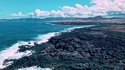 Drone flight over rugged coast with turquoise water 스톡 동영상 221362801